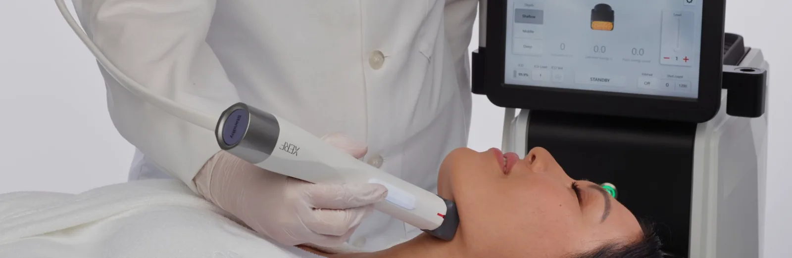 Clinician delivering XERF™ radiofrequency to a patient's jawline with the XERF™ handpiece and console